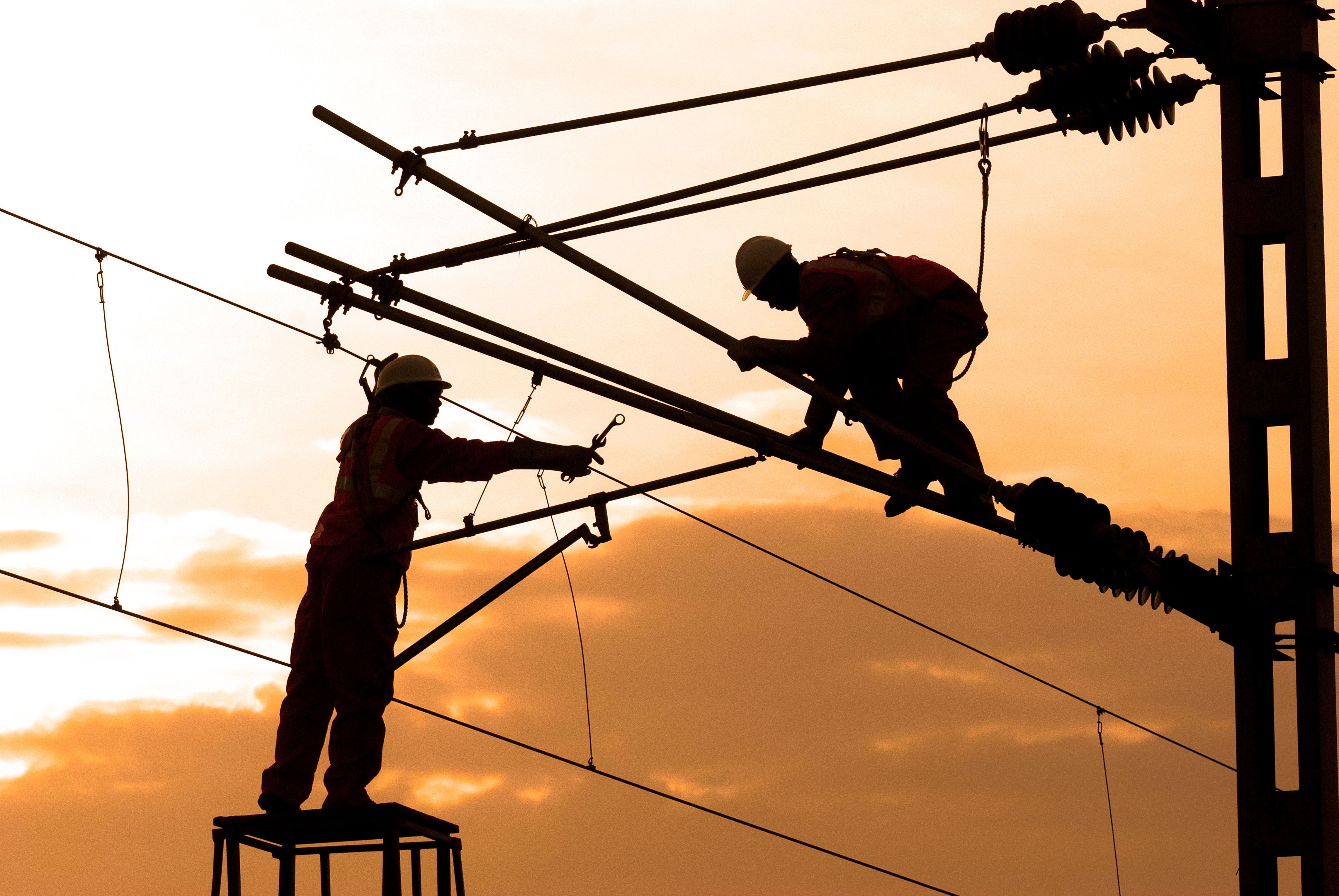 Utility workers servicing high-voltage equipment