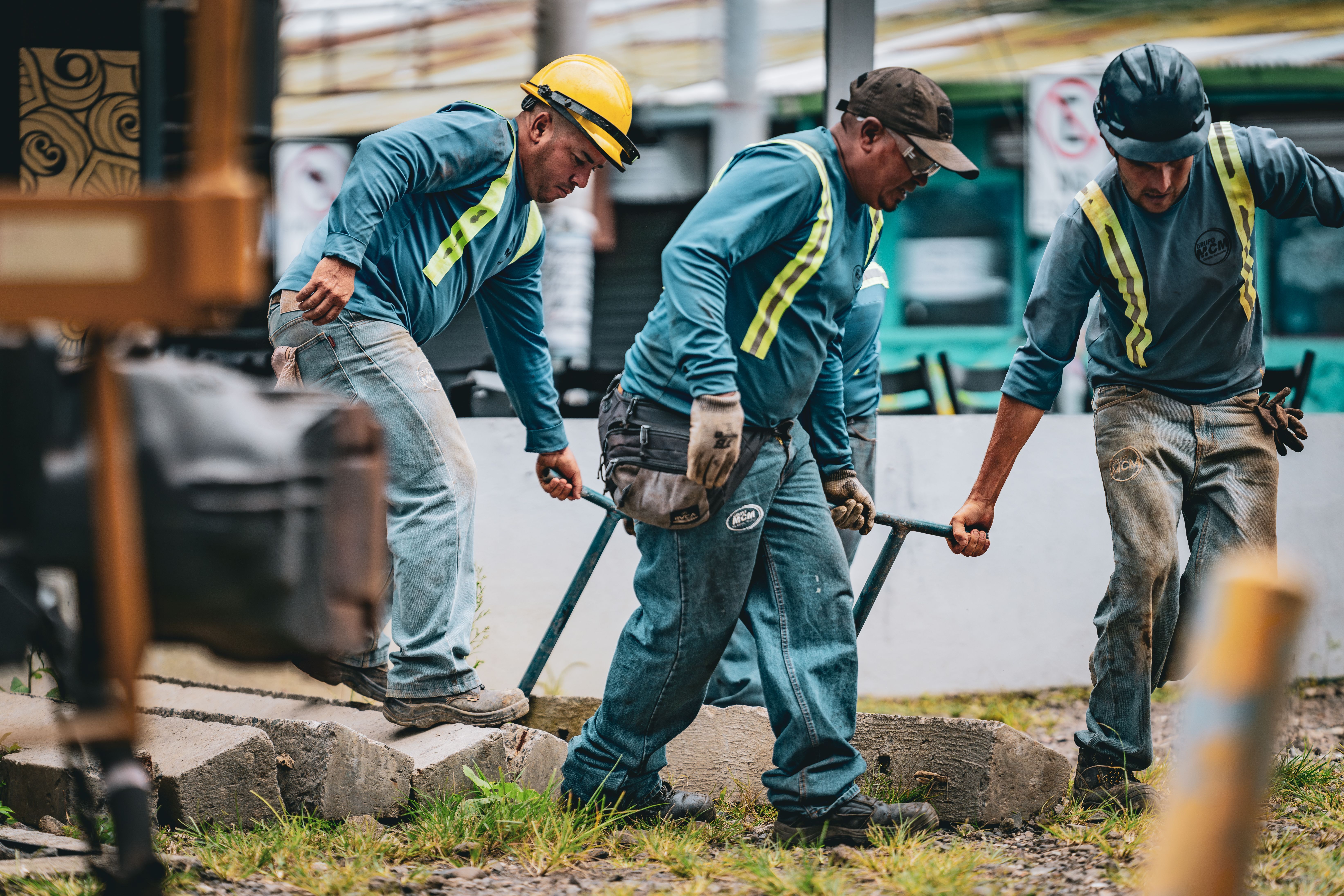 Industrial workers moving construction materials